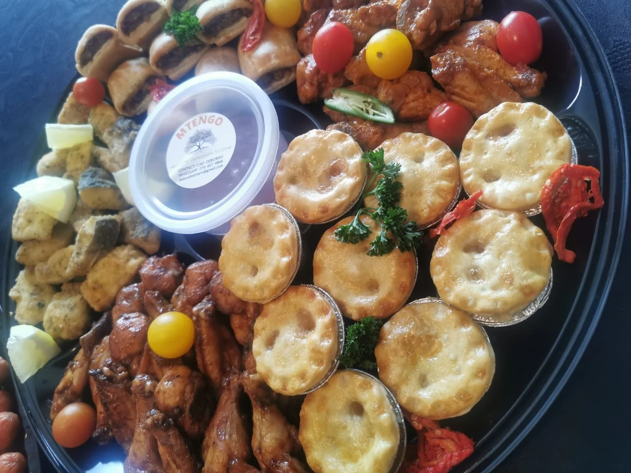 Guests dining together at a celebration dinner party catered by Mtengo